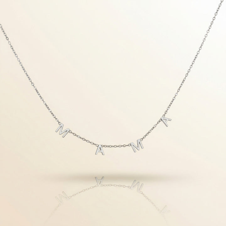 Silver necklace with 'MAMA' letters on a beige background