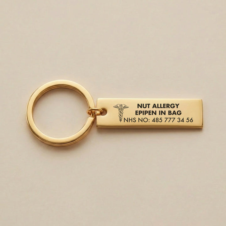 Gold medical alert keyring engraved with nut allergy epipen in bag and NHS number