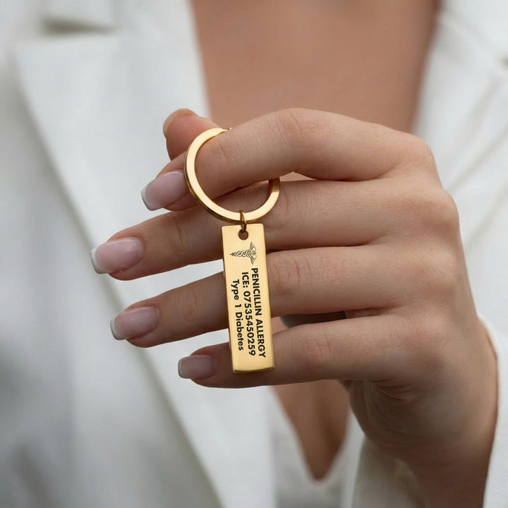 Woman holding gold medical alert keyring engraved with allergy and medical details