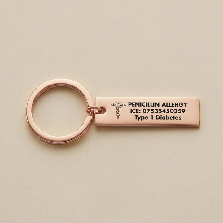 Rose gold medical alert keyring engraved with penicillin allergy and emergency contact details