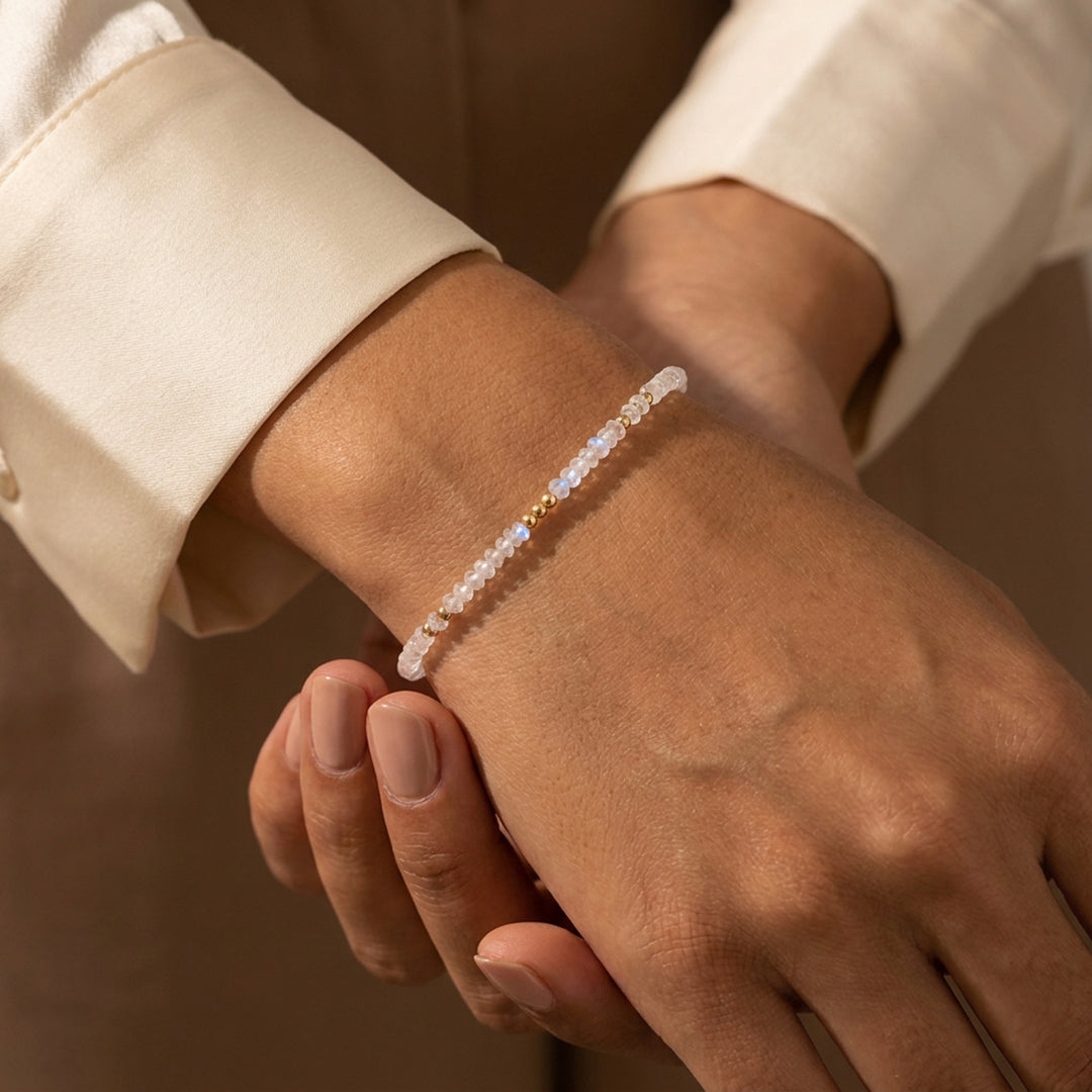 14K gold filled rainbow moonstone bracelet on wrist — June birthstone
