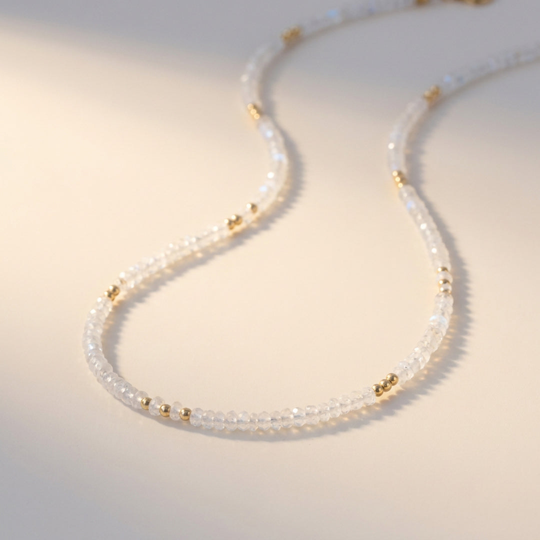 Real rainbow moonstone necklace close-up — 3mm hand-cut faceted rondelles, adularescent blue flash