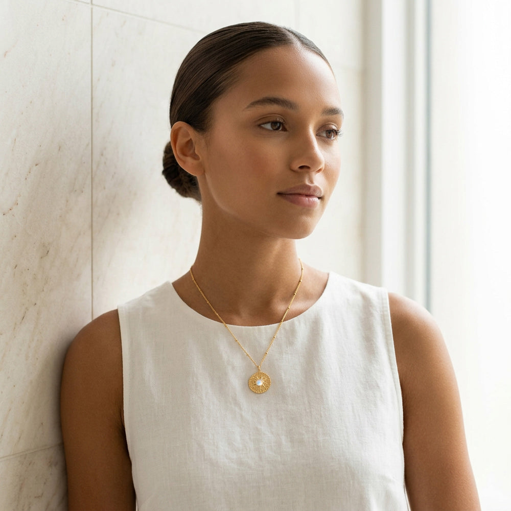 Gold moonstone sun necklace worn on chain — June birthstone gift