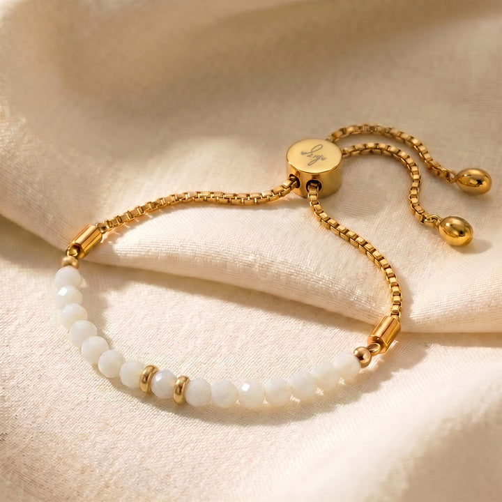 Gold mother of pearl bracelet with iridescent white mother of pearl beads on adjustable slider chain