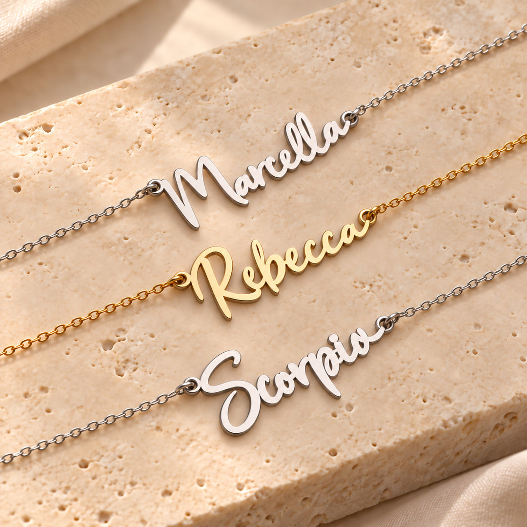 Three gold name necklaces in the same bold script font