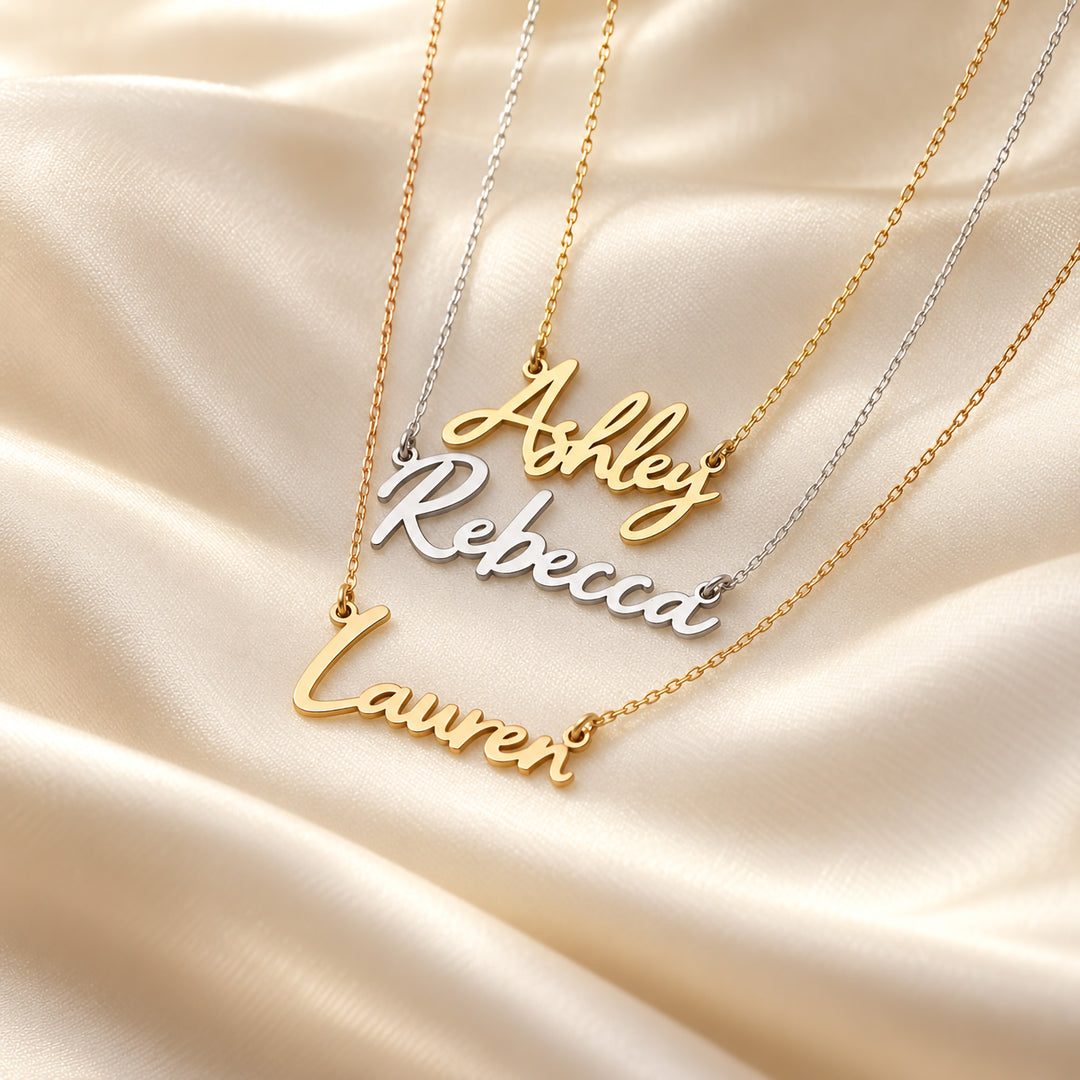 Gold and silver name necklaces in a bold script font