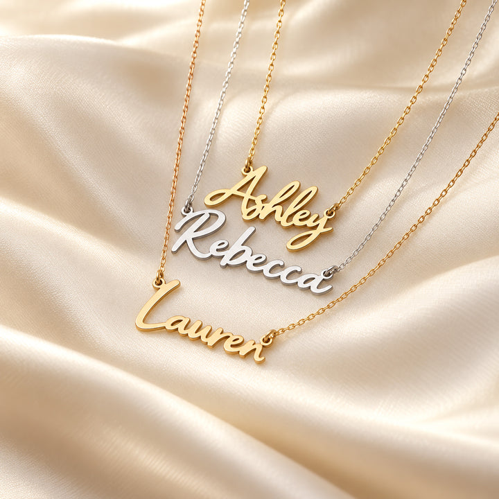 Gold and silver name necklaces in a bold script font