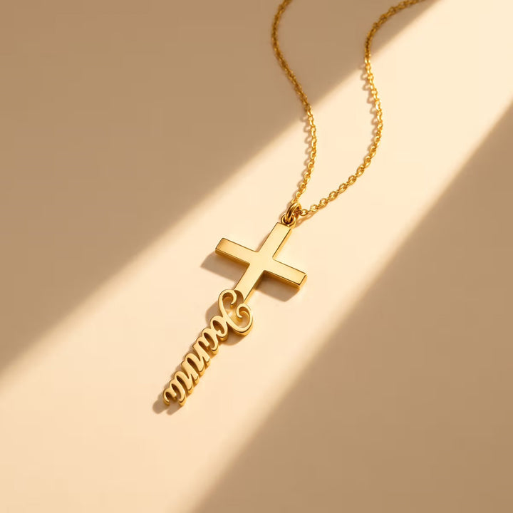 Gold cross name necklace with the name Joanna in flowing script