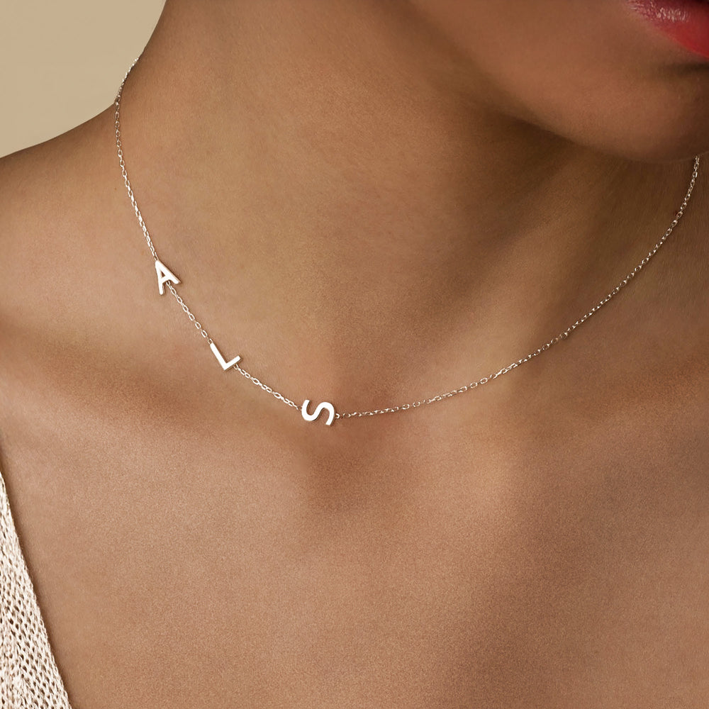 Silver sideways initial necklace with letter pendants and charm options