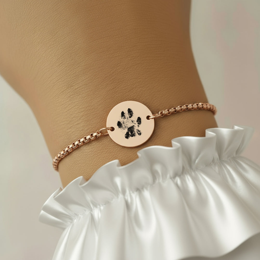 Rose gold paw print bracelet worn on wrist, remembrance jewellery