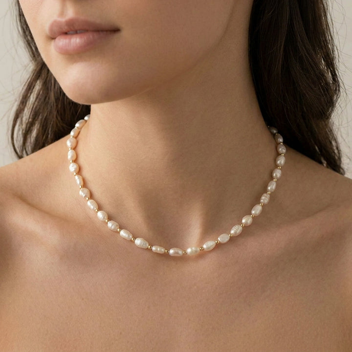 Pearl necklace on model — lustrous freshwater pearl detail, hand-strung