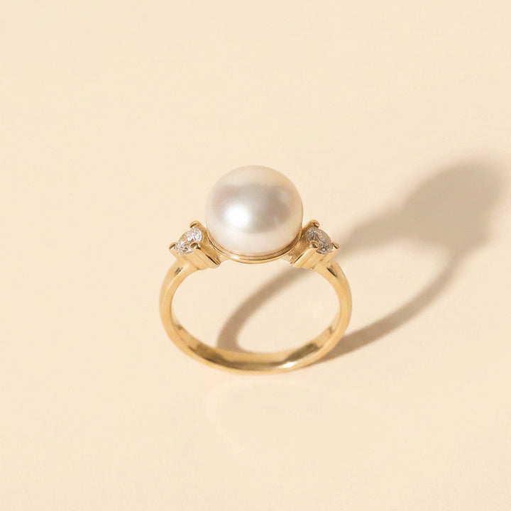 Gold vermeil pearl ring showing the 8mm freshwater pearl and 2.5mm white topaz side stones