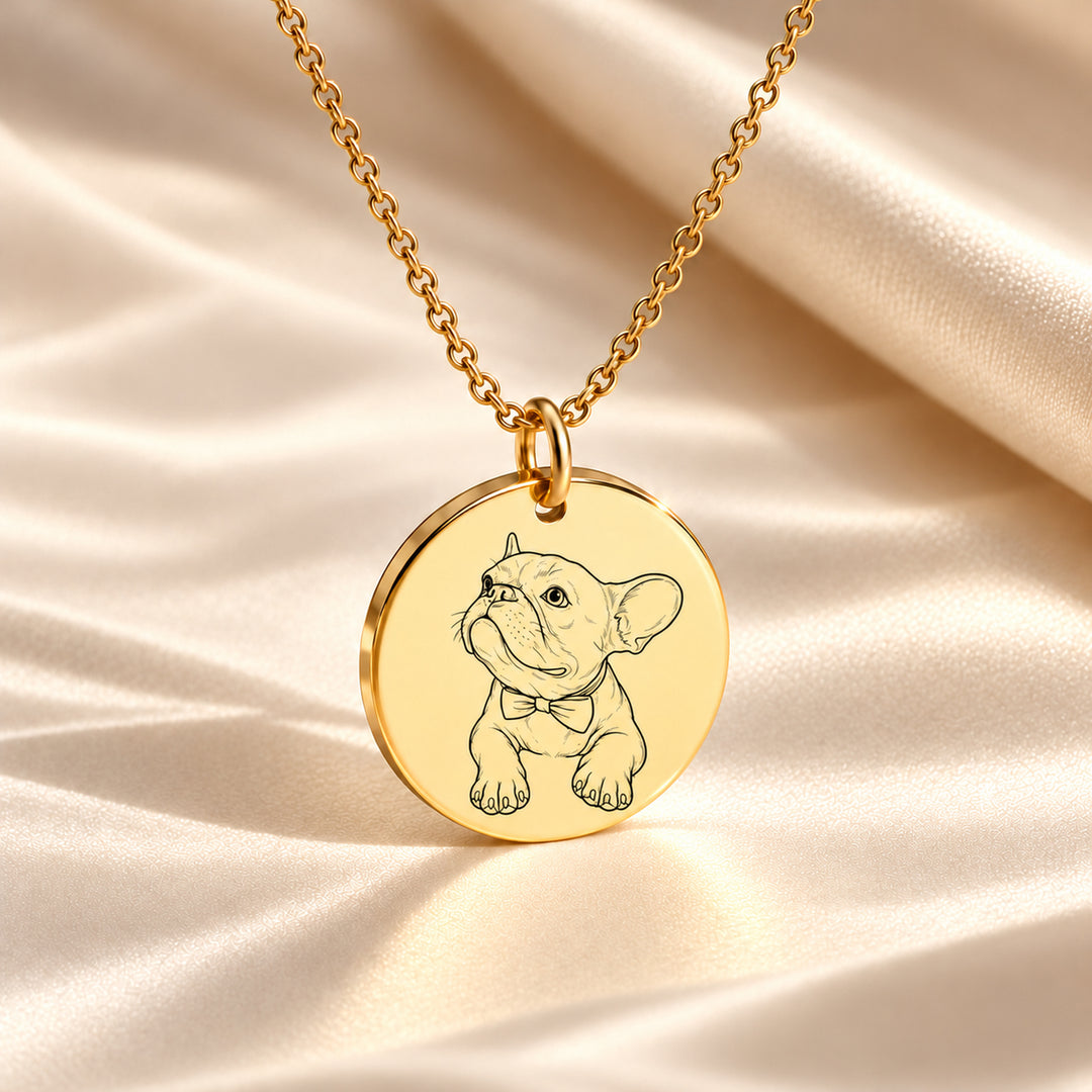 Gold pet necklace engraved with a line art portrait of a French bulldog