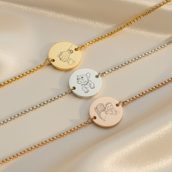 engraved photo bracelets  in silver, gold and rose gold on fabric background
