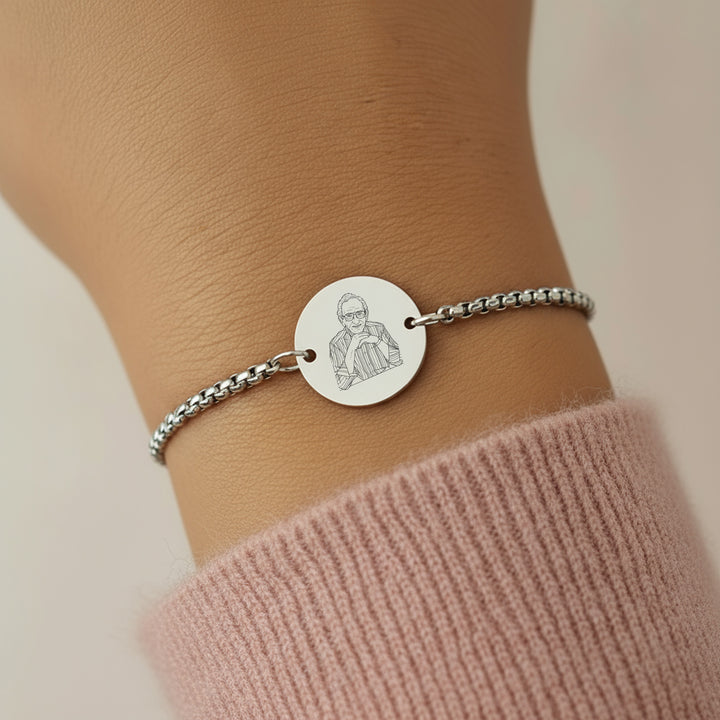 Silver bracelet with a photo engraved disc on a wrist,