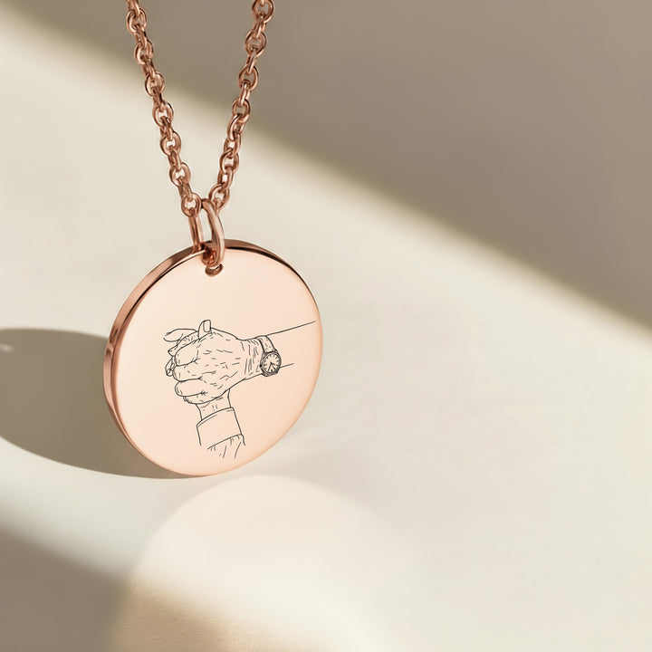 Holding hands photo engraved on a round rose gold pendant