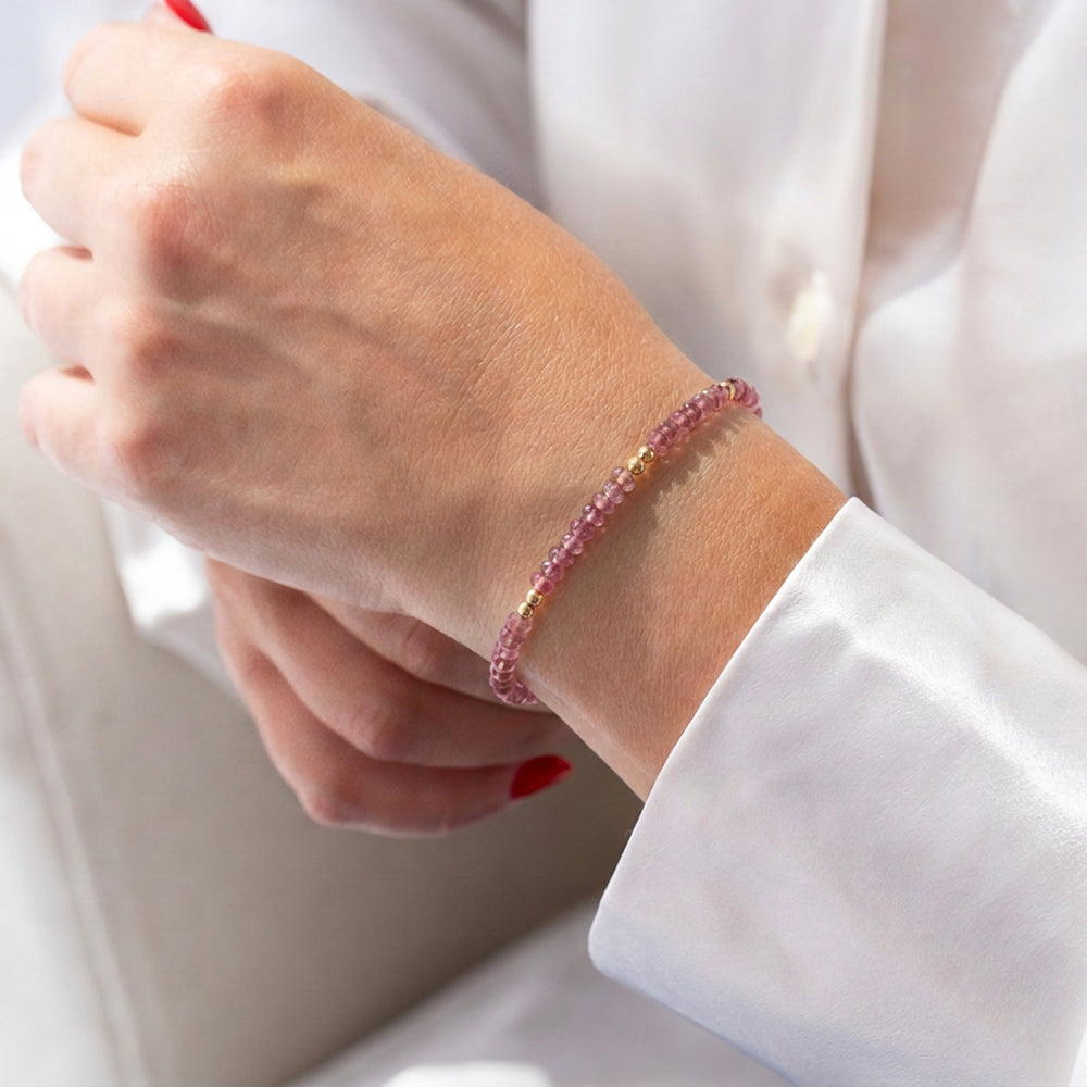 14K gold filled pink tourmaline bracelet on wrist — October birthstone