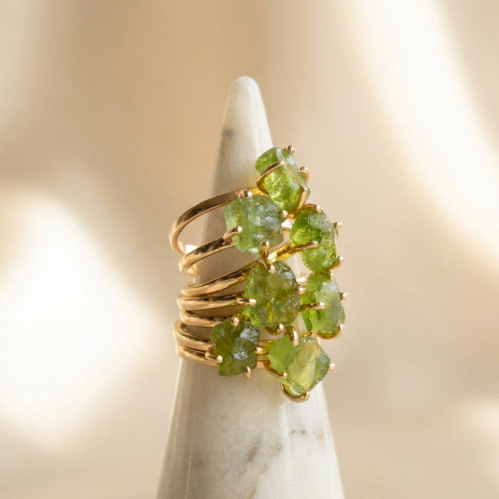 Gold vermeil raw peridot rings stacked together — Abiza August birthstone ring, each stone unique