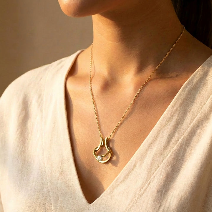 Gold ring holder necklace worn on model with V neck top