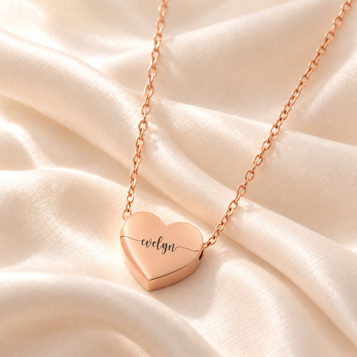 Rose gold heart name necklace engraved with the name Evelyn