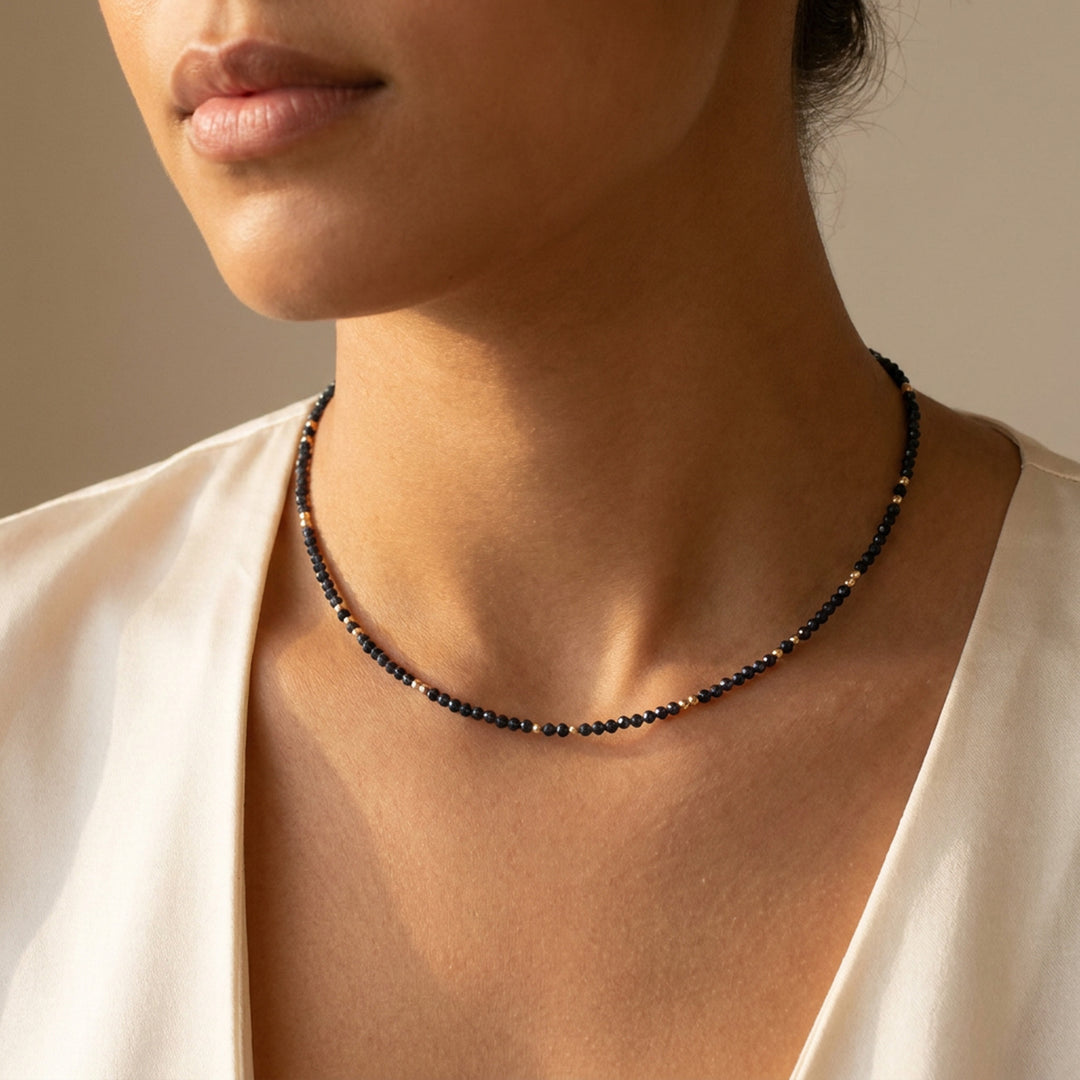 Real sapphire necklace on model — hand-strung in our Chester studio, September birthstone in natural untreated deep midnight blue