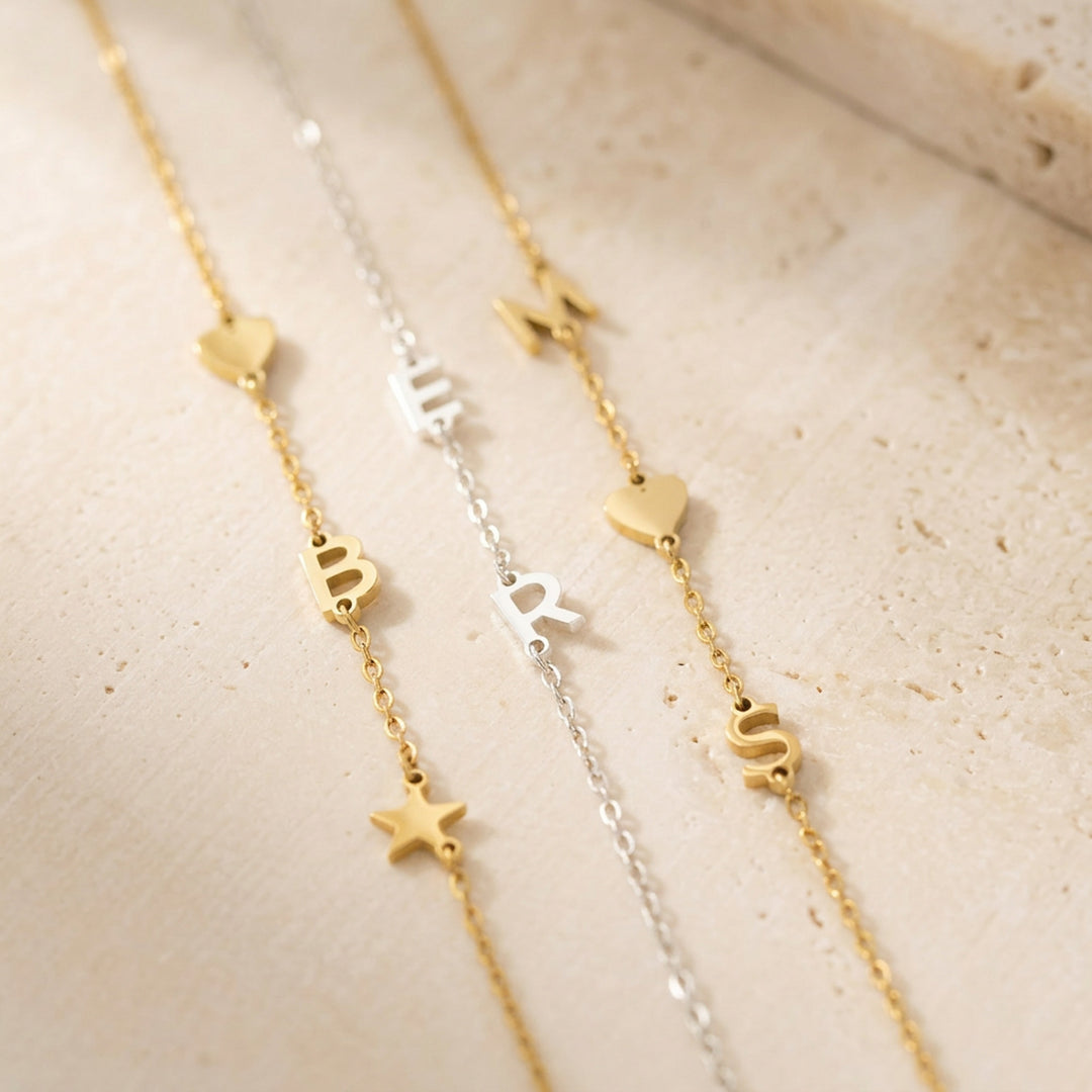 Personalised initial bracelet styled flat lay — gold and silver options