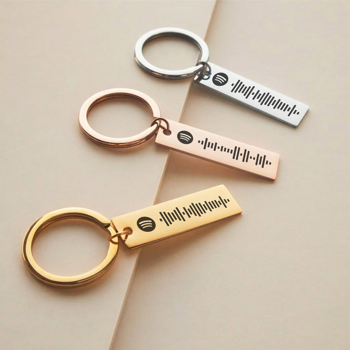 silver gold and rose gold personalised Spotify keyrings with engraved song codes
