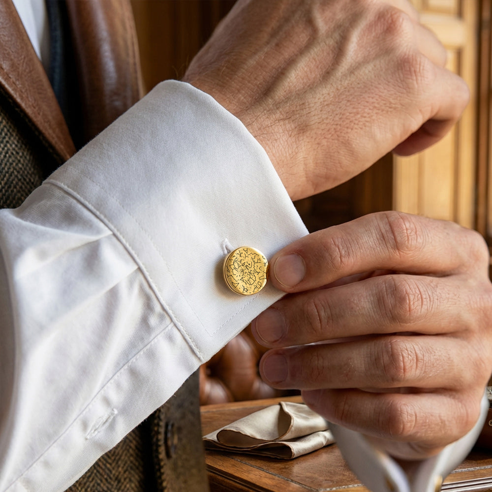 Gold constellation cufflinks worn on white shirt
