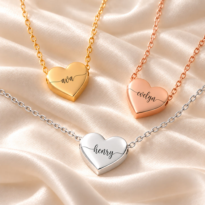 Three heart name necklaces in gold, silver and rose gold, each engraved with a different name