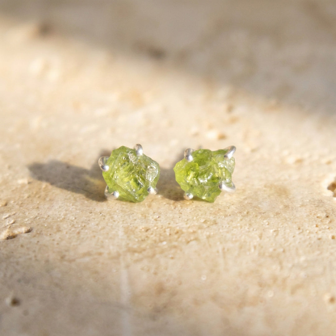 Raw peridot stud earrings in sterling silver — hand-set uncut peridot on ear posts and butterfly backs