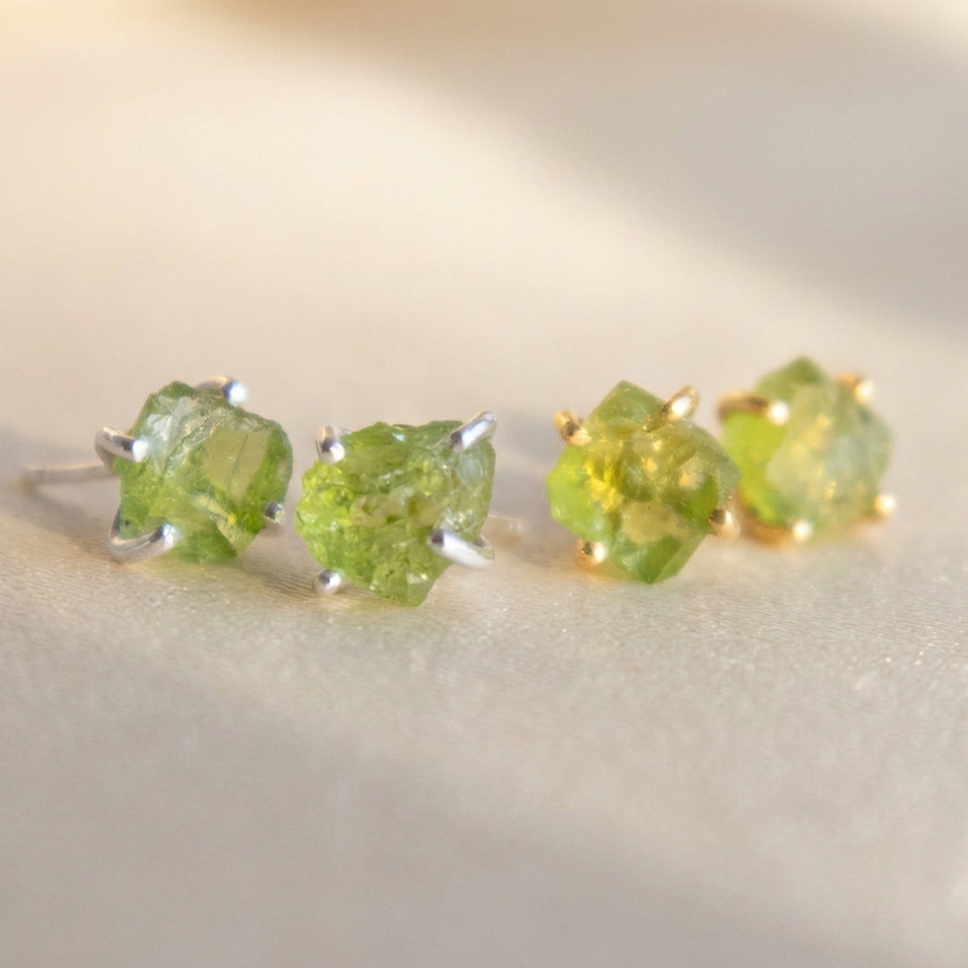 Real raw peridot stud earrings — gold and silver pairs together, natural uncut peridot crystals, August birthstone
